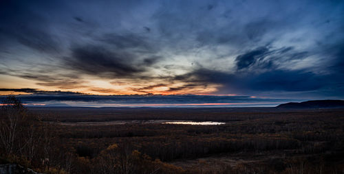 Scenic view of dramatic sky over land