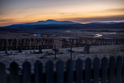 Scenic view of snowcapped mountains against sky during sunset