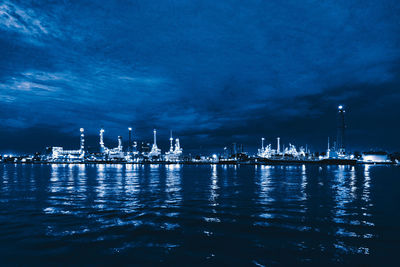 Sailboats in sea against sky at night