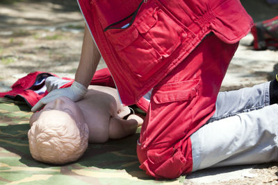 Low section of woman wearing red shoes