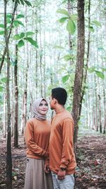 Young couple standing in forest