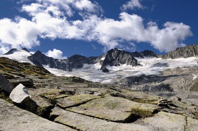 Scenic view of mountains against cloudy sky