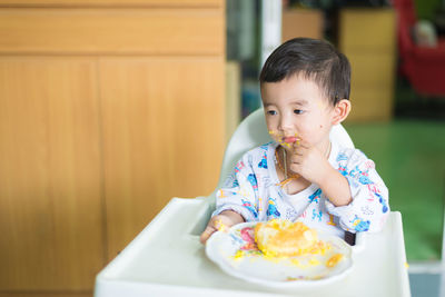 Midsection of man sitting on table