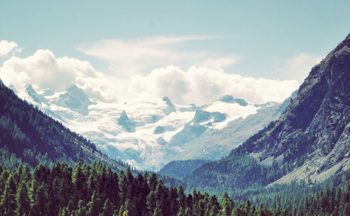 Scenic view of mountains against cloudy sky