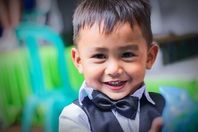 Close-up portrait of cute boy standing outdoors