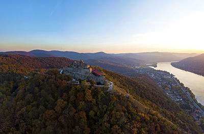 Scenic view of mountains and buildings against sky