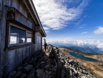 Man standing on mountain against sky