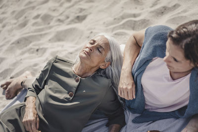 Mother and daughter relaxing on the beach