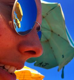 Close-up of woman with sunglasses at beach