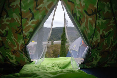 Close-up of tent seen through window