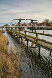 Pier over river against sky