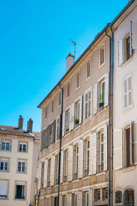 Low angle view of residential building against blue sky