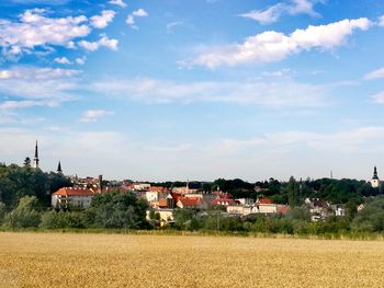 Houses on field against sky