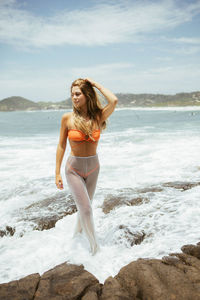 Young woman standing at beach