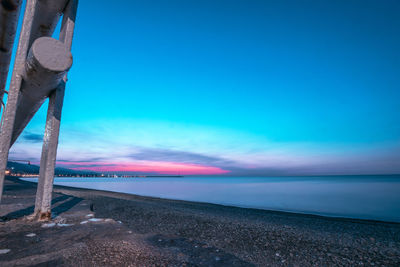 Scenic view of beach against blue sky