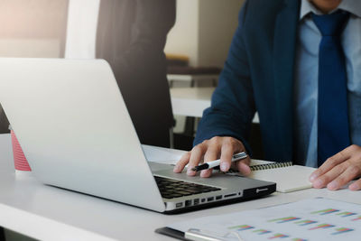 Low angle view of man using laptop on table