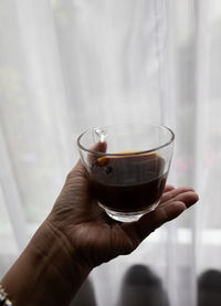 Close-up of hand holding wineglass