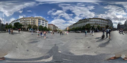 Panoramic view of people in city against sky