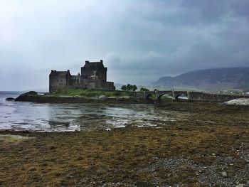 Eilean donan castle, scotland, highlands, historic building against sky