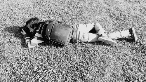 High angle view of man sleeping on grass