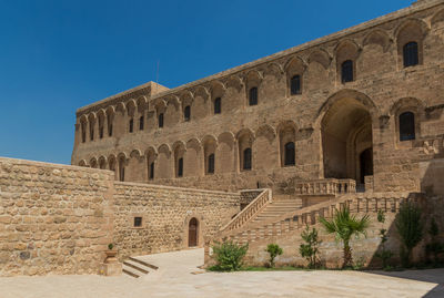 Low angle view of historical building against blue sky