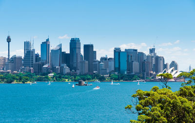 Buildings in city against blue sky