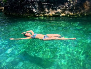 Woman swimming in river