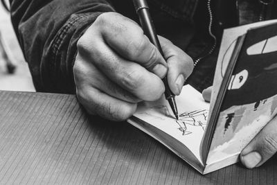 Close-up of man working on table