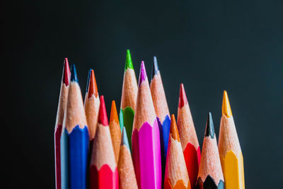 Close-up of colored pencils against black background