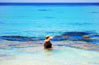 Rear view of woman in sea