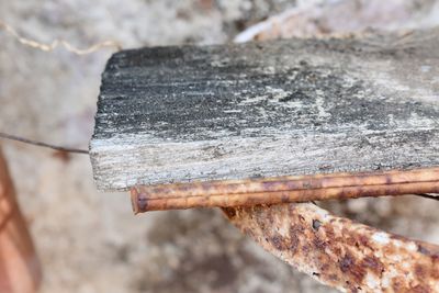 High angle view of rusty metal on wood