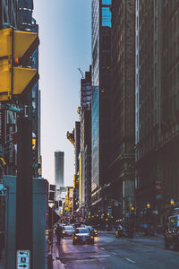 Illuminated city street against sky