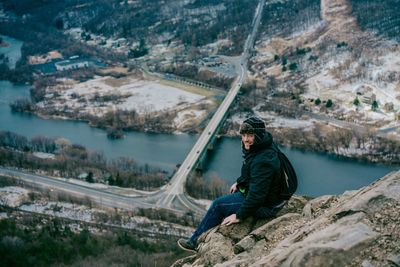 High angle view of man sitting on a peak