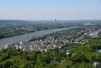 High angle view of townscape by sea against sky