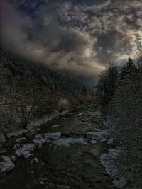 Snow covered land against sky