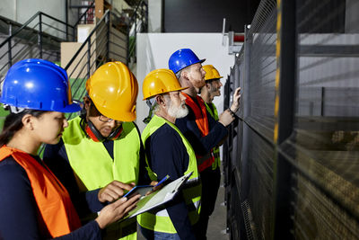 Workers standing in factory workshop