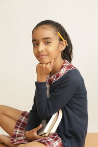 Portrait of smiling girl holding book