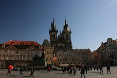 Group of people in front of buildings in city