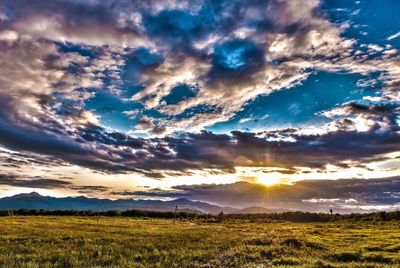 Scenic view of landscape against dramatic sky