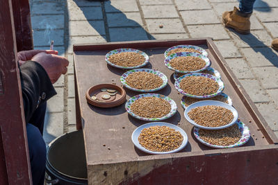 Low section of man for sale at market stall