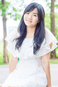 Portrait of a beautiful young woman standing outdoors