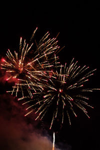 Low angle view of firework display at night