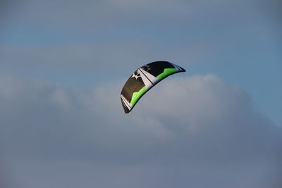 Low angle view of paraglide in cloudy sky