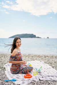 Young woman sitting on beach