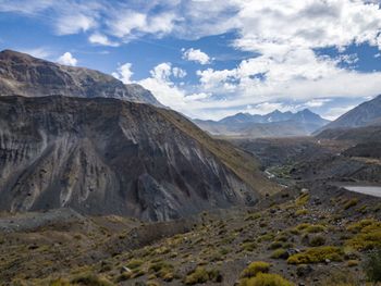 Scenic view of mountains against cloudy sky