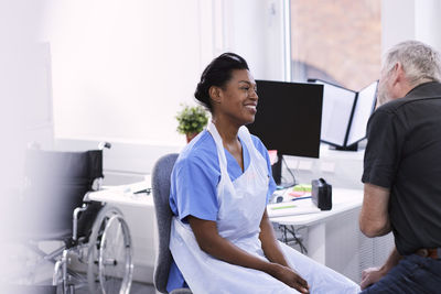 Smiling female doctor with senior patient