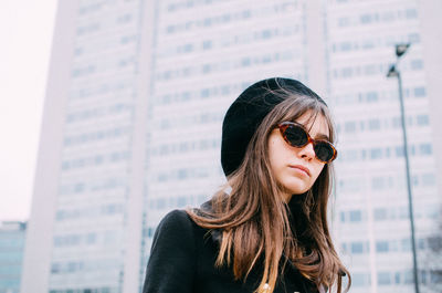 Woman standing against building in city