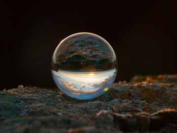 Close-up of crystal ball on rock