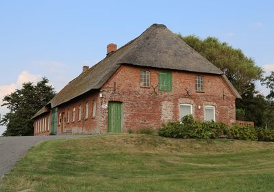 Exterior of house on field against sky