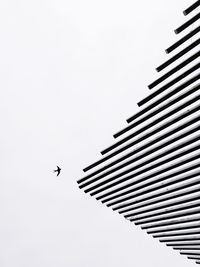 Low angle view of airplane flying against clear sky
